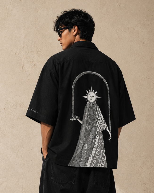 eternal prints shirt with the sun character holding the snake at the back