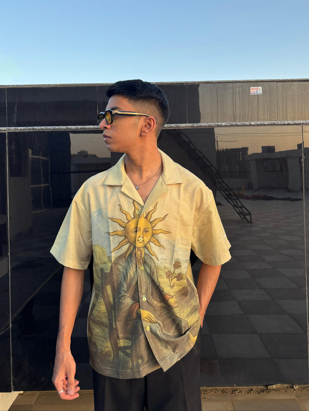 Person wearing a shirt with a sun design outdoors
