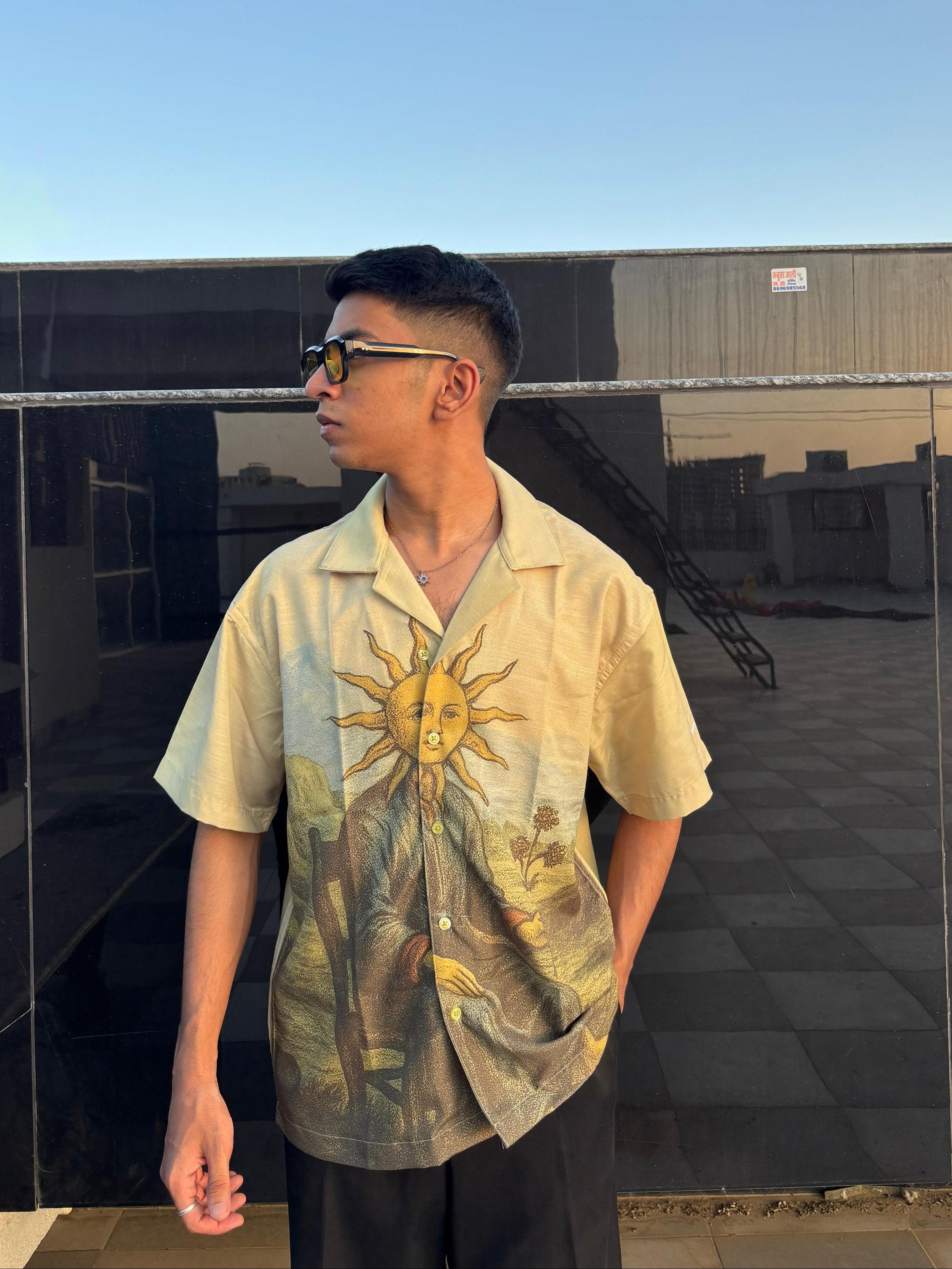 Person wearing a shirt with a sun design outdoors